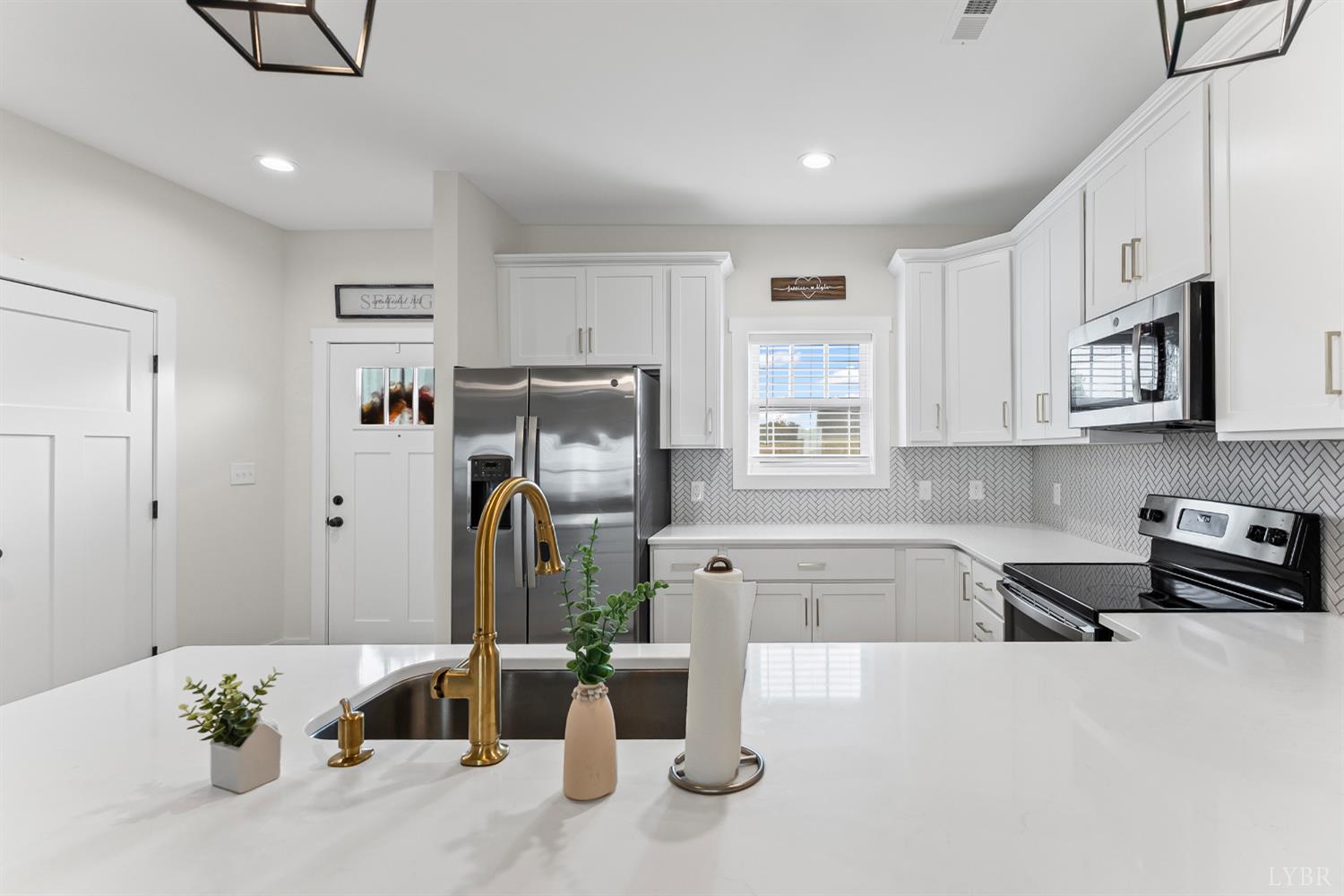 556 Leesville Road, Unit 1001 Lynchburg, VA 24502 - Photo 7 of 22 a kitchen with stainless steel appliances kitchen island granite countertop a refrigerator and microwave