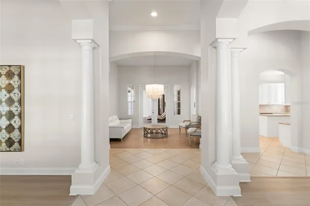 a living room with furniture and a chandelier