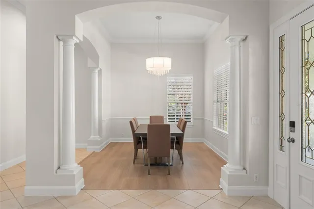 a view of a dining room with furniture and a chandelier