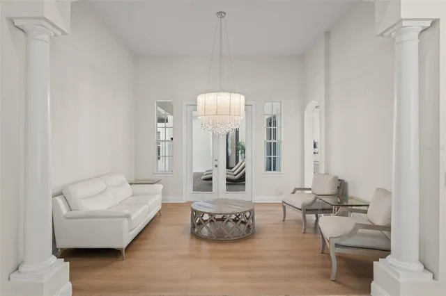 an empty room with a window and wooden floor