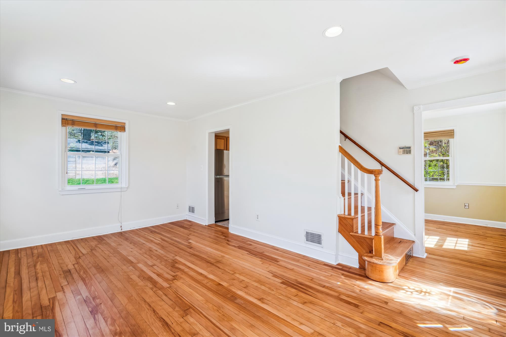 10115 Tenbrook Drive Silver Spring, MD 20901 - Photo 16 of 53 a view of an empty room with window and wooden floor