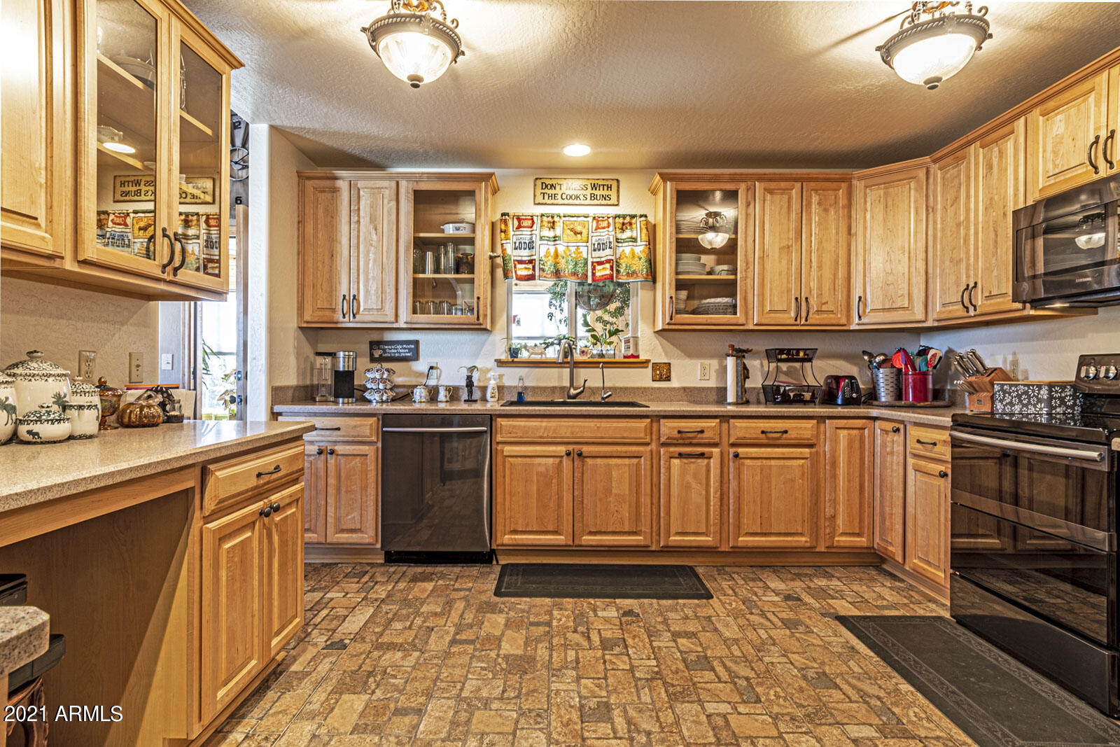 1057 Casper Lane Show Low, AZ 85901 - Photo 11 of 37 Brick tile floor and lots of cabinets
