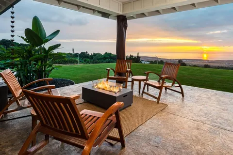 a view of a patio with dining table and chairs with a swimming pool