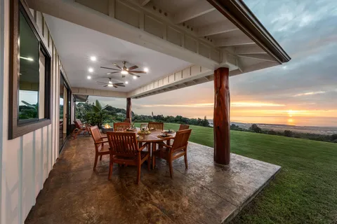 a view of a porch with chairs and backyard
