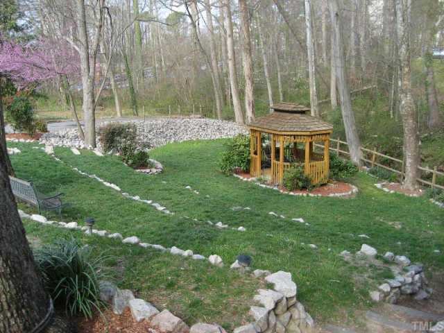 1427 Seminole Trail Raleigh, NC 27609 - Photo 2 of 8 a view of a backyard with table and chairs and potted plants