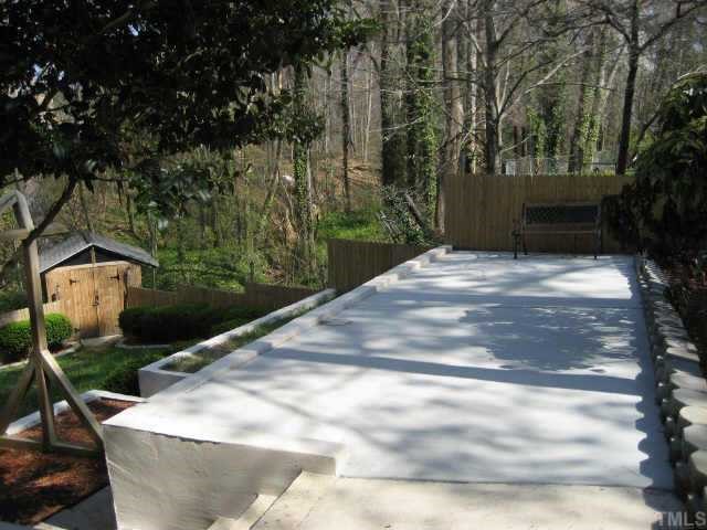 1427 Seminole Trail Raleigh, NC 27609 - Photo 3 of 8 a view of a yard with plants and large trees