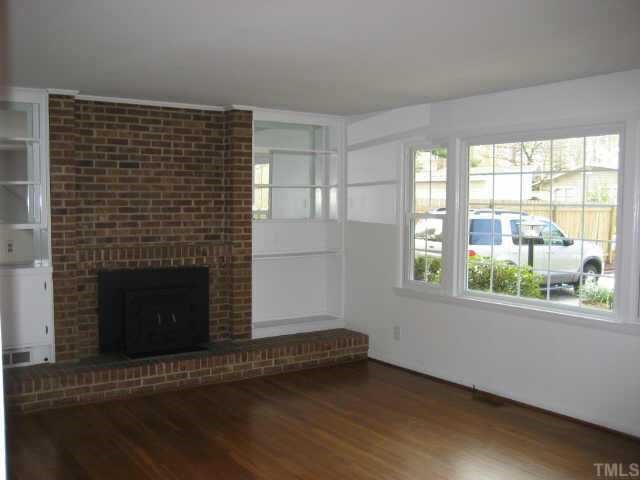 1427 Seminole Trail Raleigh, NC 27609 - Photo 4 of 8 a view of an empty room with wooden floor and a window