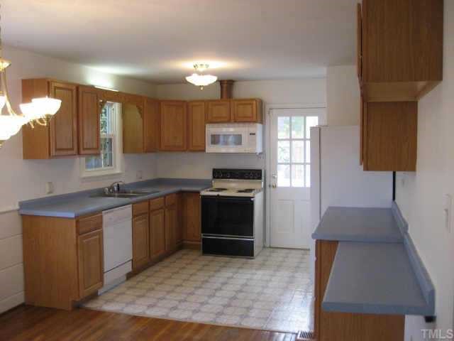 1427 Seminole Trail Raleigh, NC 27609 - Photo 5 of 8 a kitchen with stainless steel appliances granite countertop a stove a sink and a refrigerator