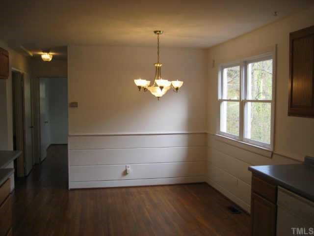 1427 Seminole Trail Raleigh, NC 27609 - Photo 6 of 8 a view of a room with wooden floor and windows