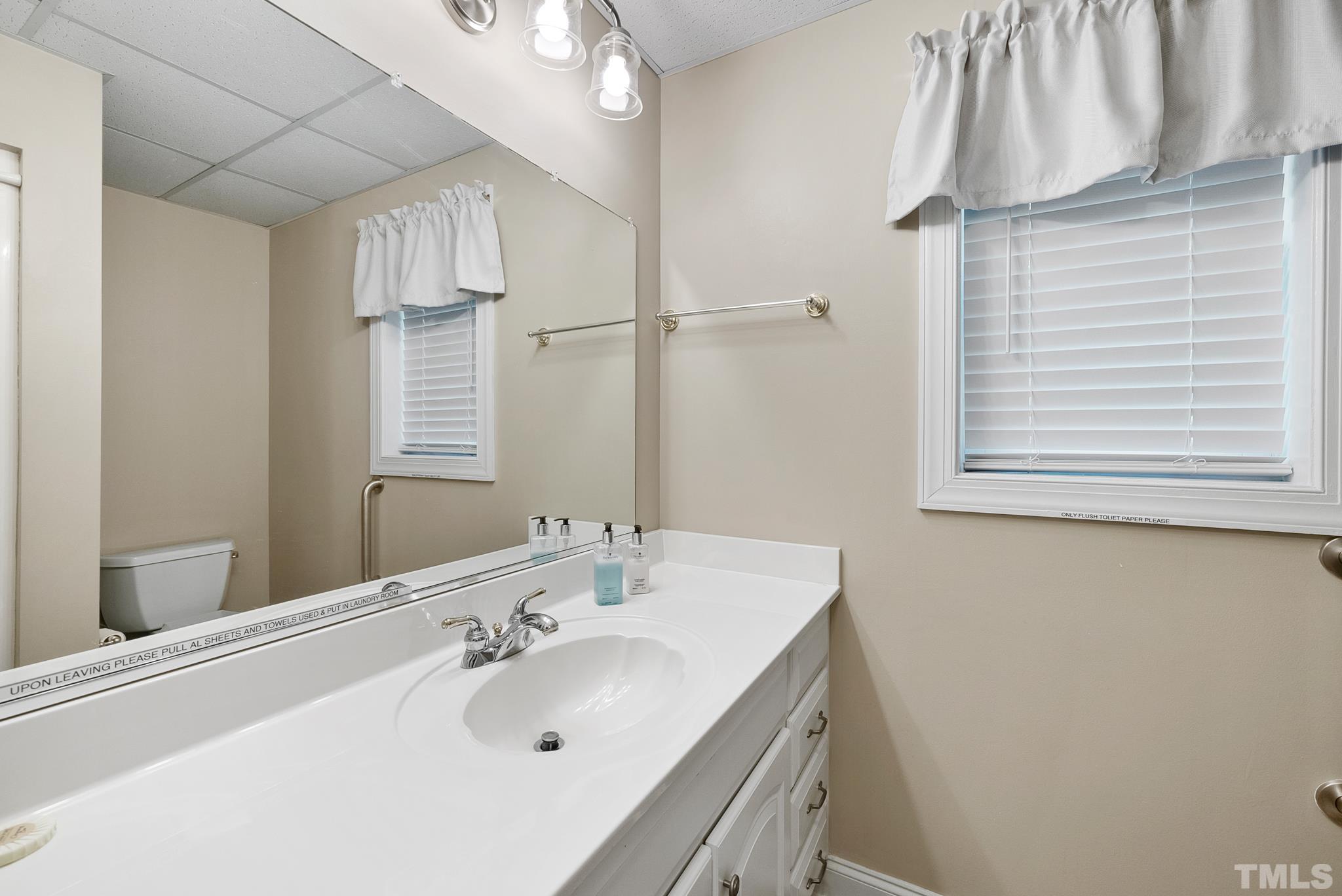 339 Velvet Road Semora, NC 27343 - Photo 38 of 68 a bathroom with a sink a mirror and a shower
