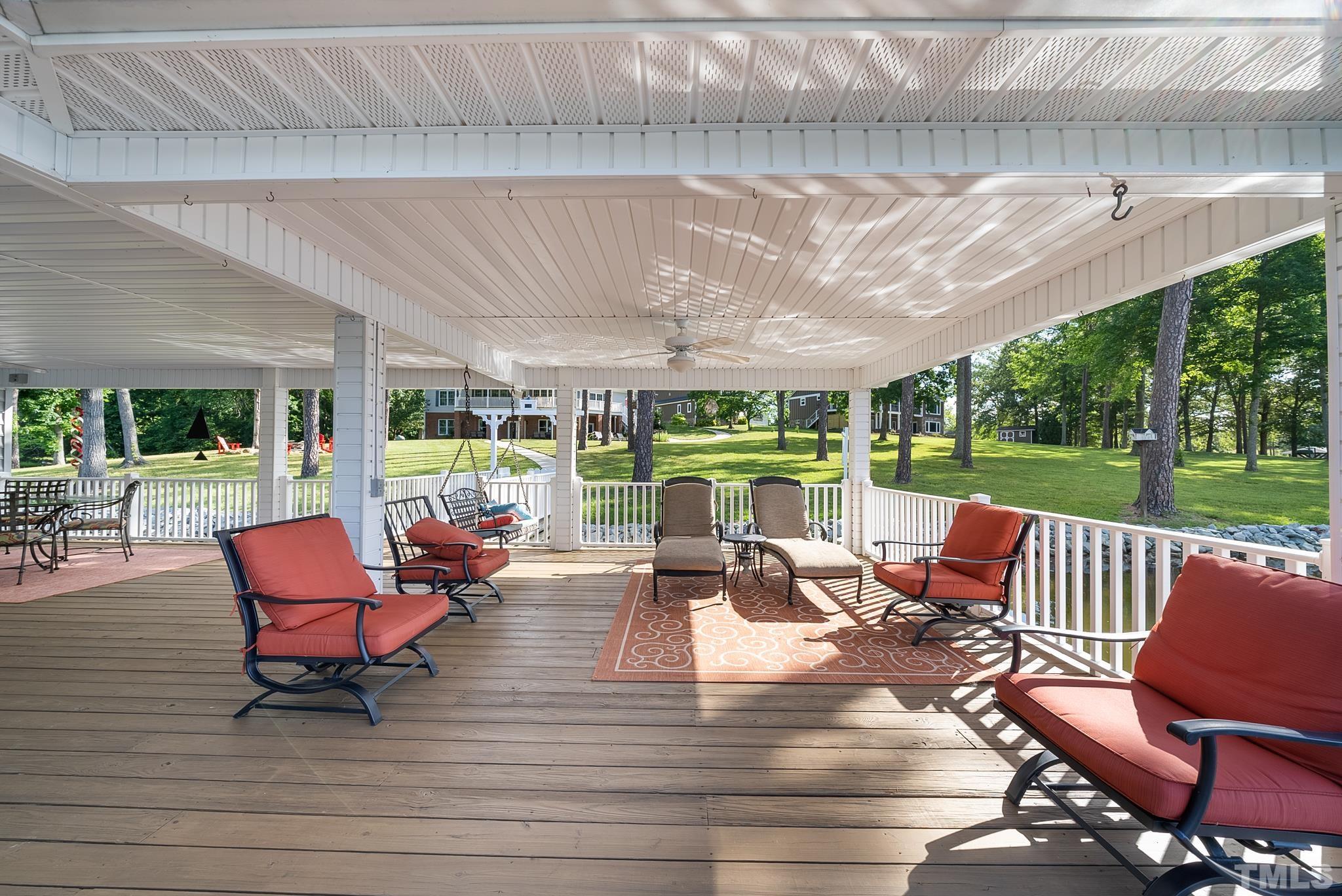 339 Velvet Road Semora, NC 27343 - Photo 58 of 68 a view of a patio with couches chairs and a floor to ceiling window