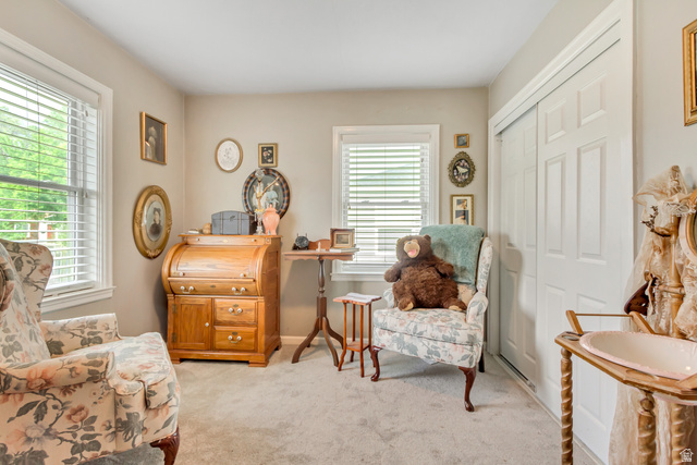 65 West 700 North Bountiful, UT 84010 - Photo 20 of 29 Carpeted room featuring multiple windows with blinds, a built-in closet with bi-fold doors, and neutral wall tones