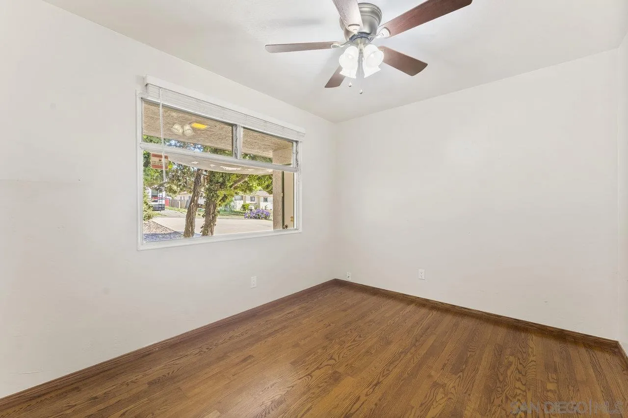 1822 Wight Way El Cajon, CA 92021 - Photo 17 of 45 an empty room with a window and wooden floor