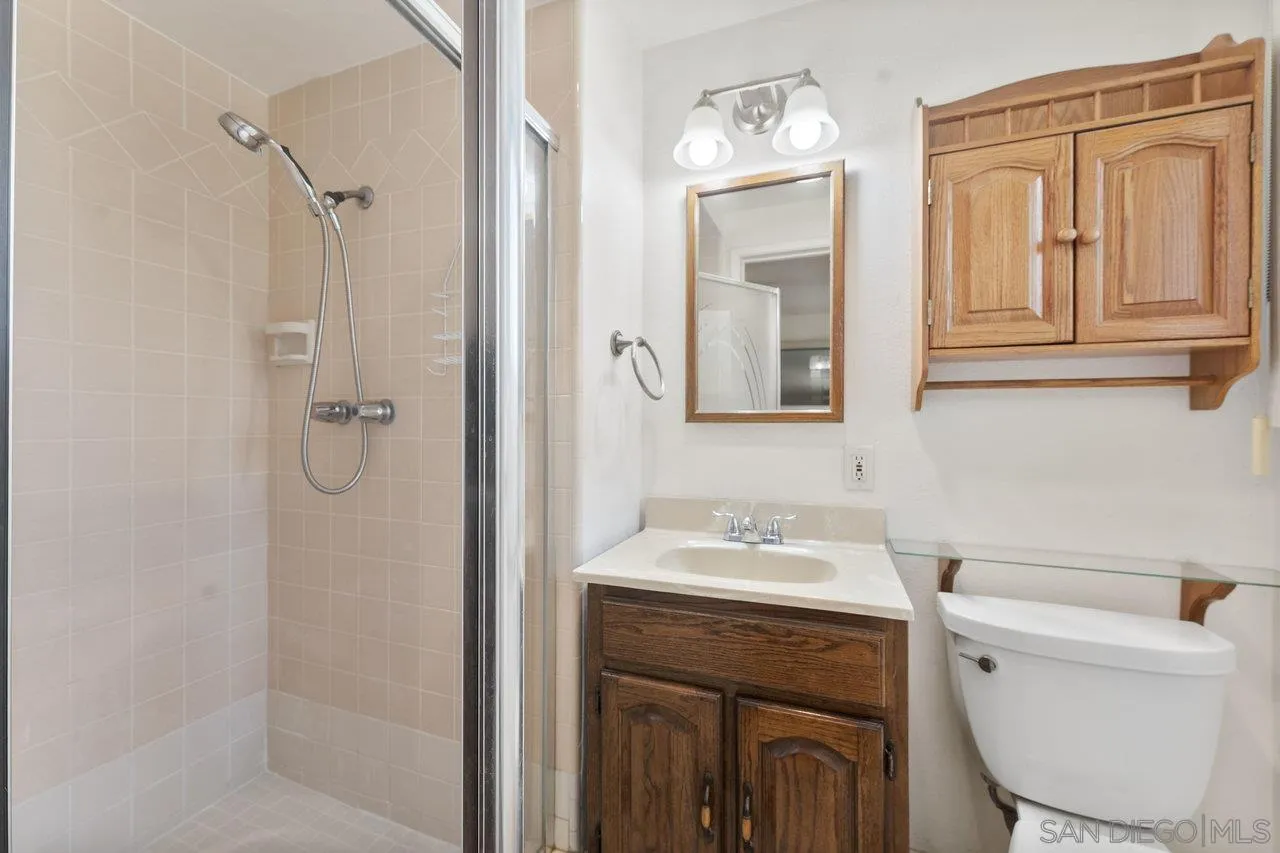1822 Wight Way El Cajon, CA 92021 - Photo 26 of 45 a bathroom with a sink toilet vanity and shower