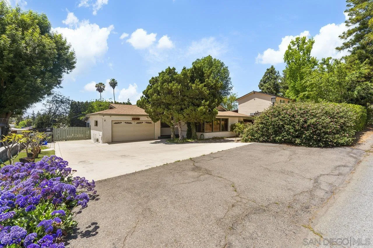 1822 Wight Way El Cajon, CA 92021 - Photo 3 of 45 a front view of a house with a yard and fountain in middle