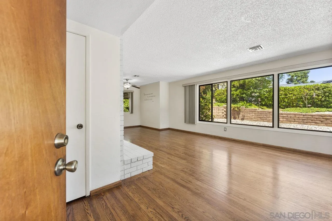 1822 Wight Way El Cajon, CA 92021 - Photo 6 of 45 an empty room with wooden floor and windows