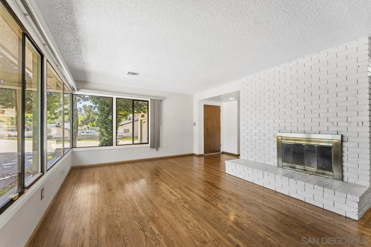 1822 Wight Way El Cajon, CA 92021 - Photo 9 of 45 a view of an empty room with a fireplace and a window