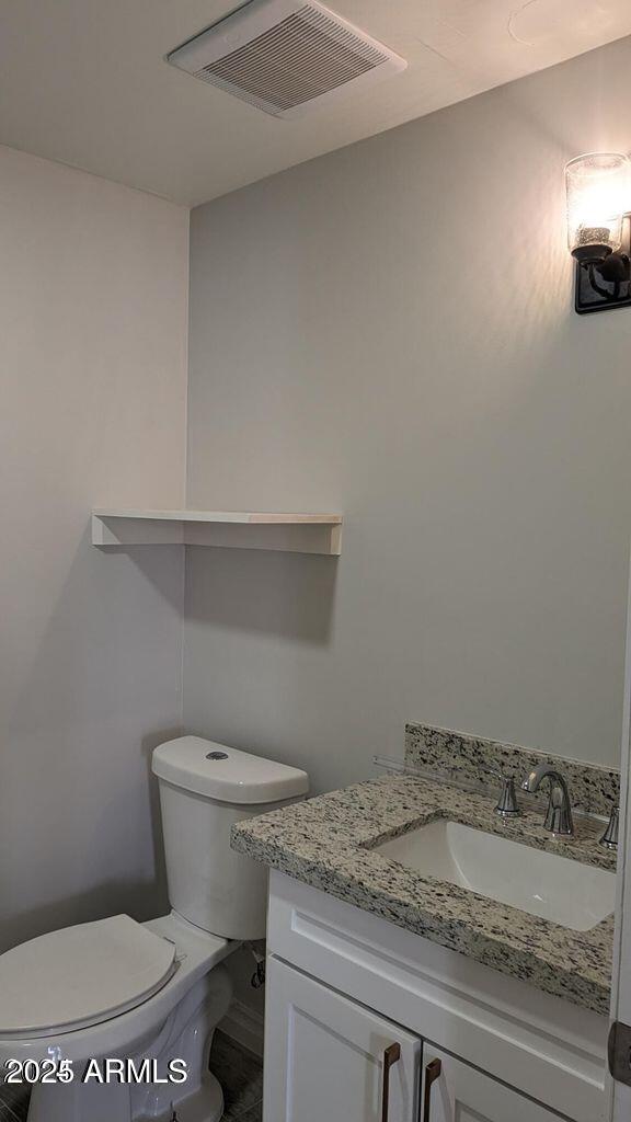 224 South Adonis Avenue Miami, AZ 85539 - Photo 6 of 13 a bathroom with a granite countertop toilet and a sink