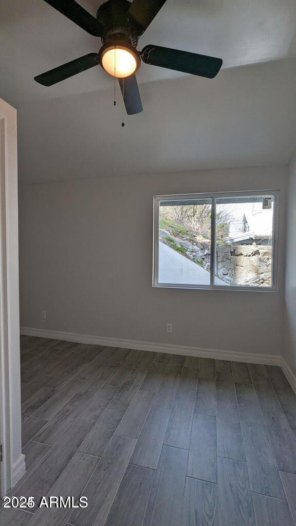 224 South Adonis Avenue Miami, AZ 85539 - Photo 10 of 13 an empty room with wooden floor and windows