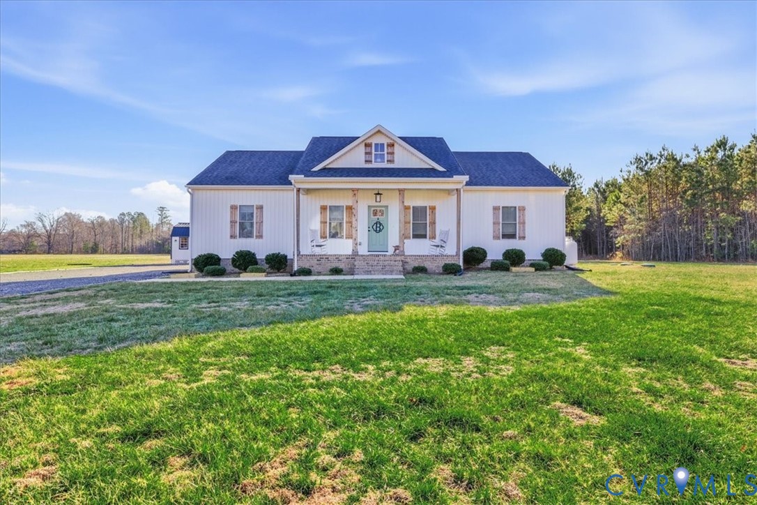 a view of a house with a big yard and potted plants