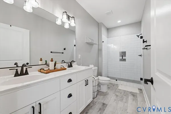 a bathroom with a sink double vanity granite and a mirror
