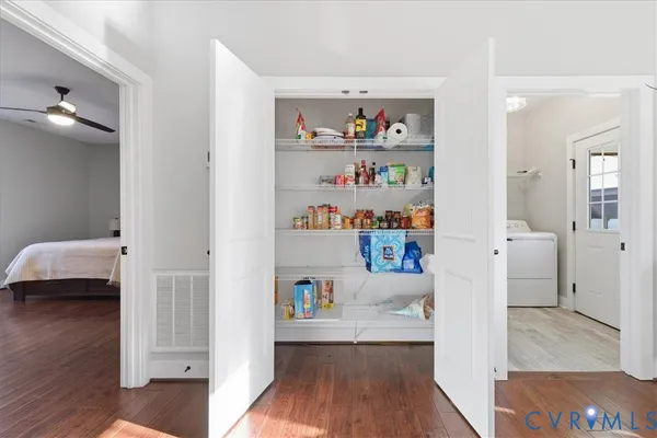 a area with lots of clutter and wooden floor