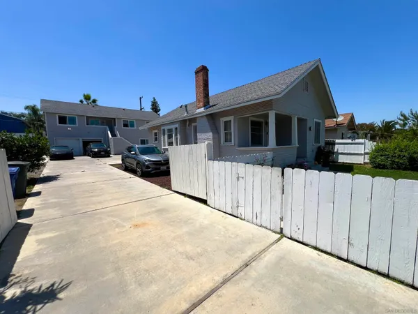 a view of a house with wooden fence