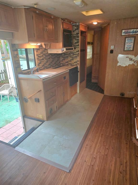 3000 Clarcona Road, Unit 770 Apopka, FL 32703 - Photo 3 of 5 a kitchen with stainless steel appliances granite countertop a stove a sink and a refrigerator