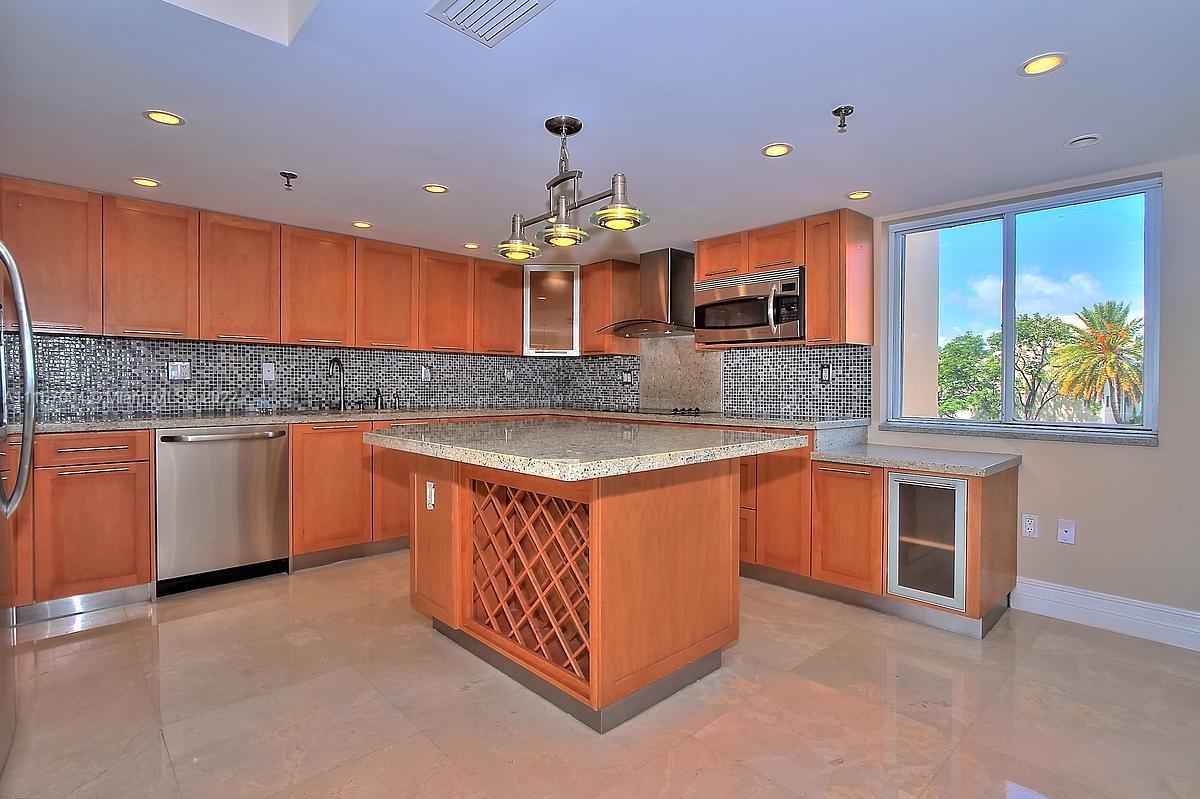650 Ocean Drive, Unit 3C Key Biscayne, FL 33149 - Photo 4 of 16 a kitchen with stainless steel appliances granite countertop a sink a stove and a refrigerator