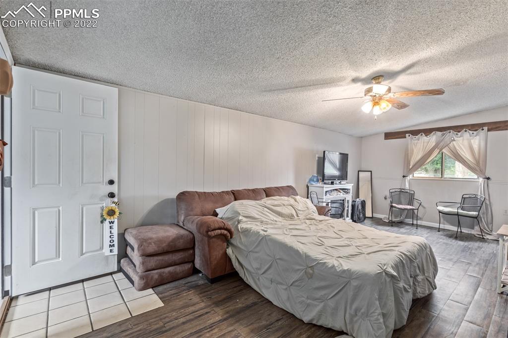 732 South Chestnut Street Elizabeth, CO 80107 - Photo 14 of 26 a bedroom with a bed and a chandelier