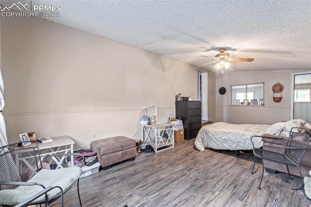 732 South Chestnut Street Elizabeth, CO 80107 - Photo 15 of 26 a bedroom with furniture and a wooden floor