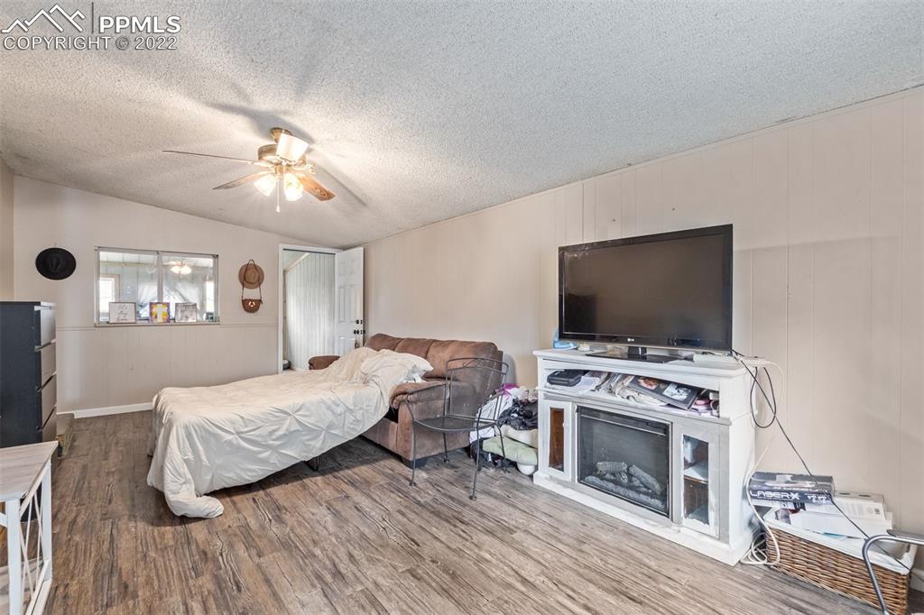 732 South Chestnut Street Elizabeth, CO 80107 - Photo 16 of 26 a bedroom with furniture and a flat screen tv