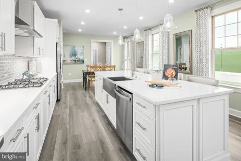 a kitchen with a sink a counter top space stainless steel appliances and a window