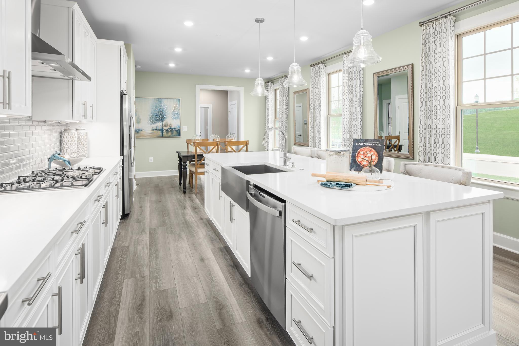 1 Mayapple Lane Frederick, MD 21702 - Photo 5 of 18 a kitchen with a sink a counter top space stainless steel appliances and a window