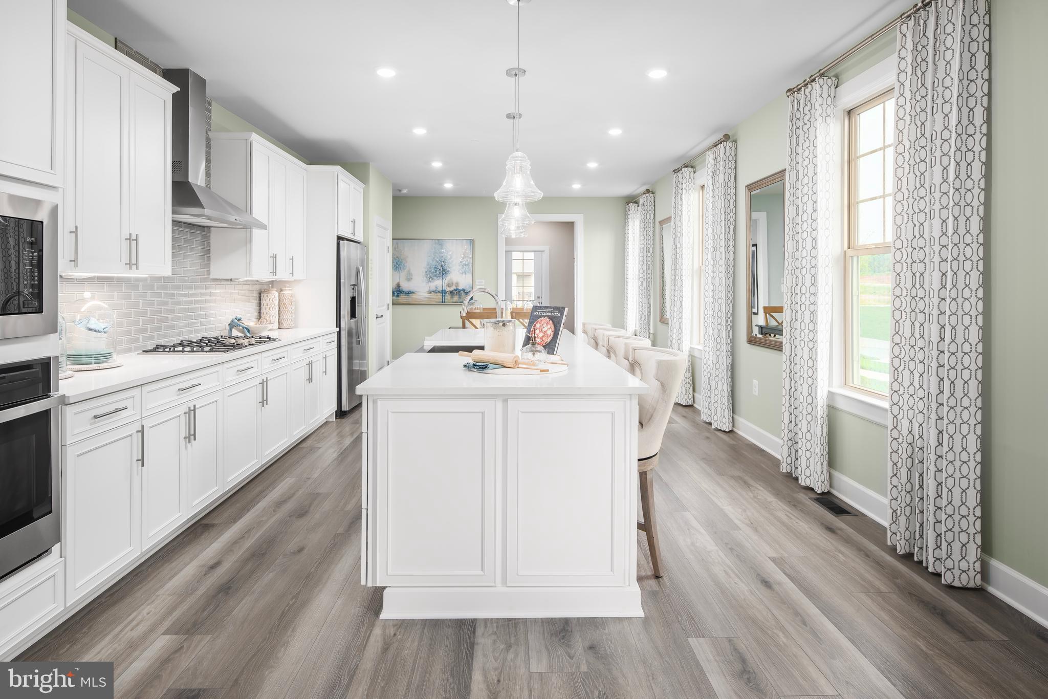 1 Mayapple Lane Frederick, MD 21702 - Photo 6 of 18 a kitchen with a sink stove cabinets and wooden floor