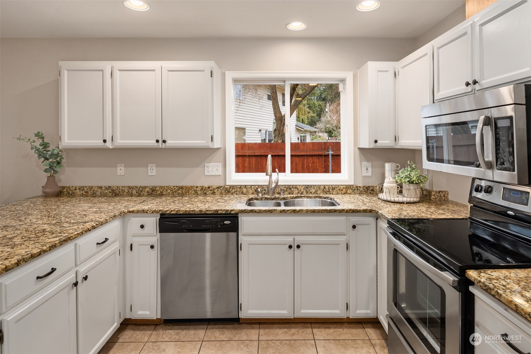 8722 Bowdoin Way Edmonds, WA 98026 - Photo 12 of 40 a kitchen with granite countertop a sink stove and cabinets