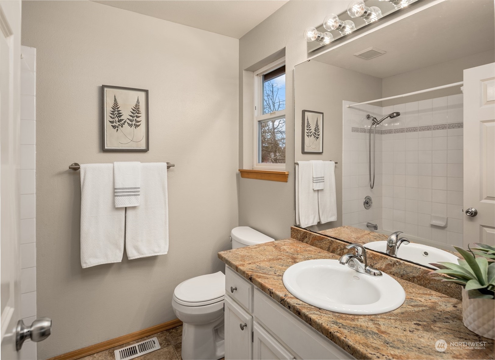 8722 Bowdoin Way Edmonds, WA 98026 - Photo 20 of 40 a bathroom with a granite countertop sink toilet and mirror