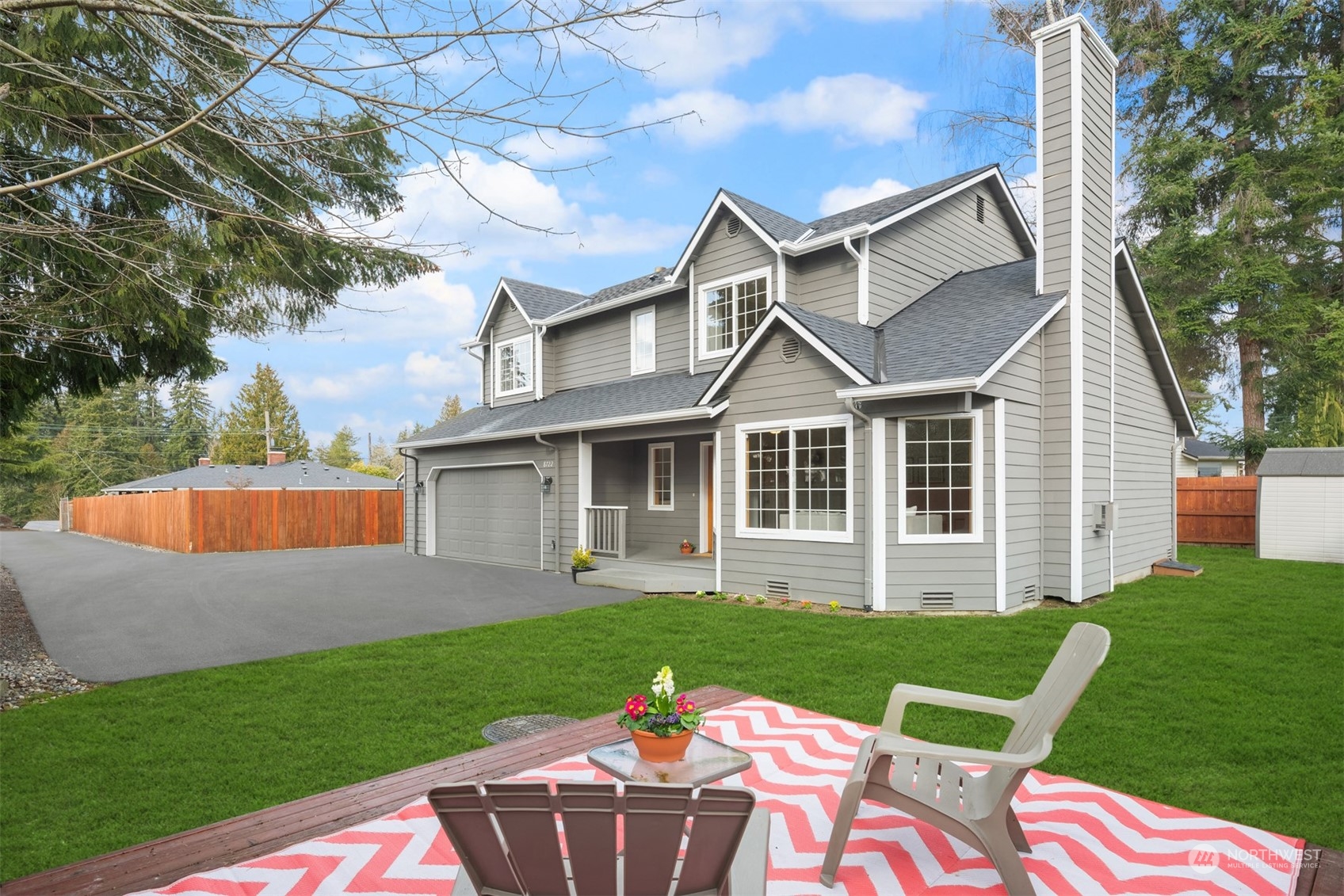 8722 Bowdoin Way Edmonds, WA 98026 - Photo 3 of 40 a front view of a house with a yard table and chairs