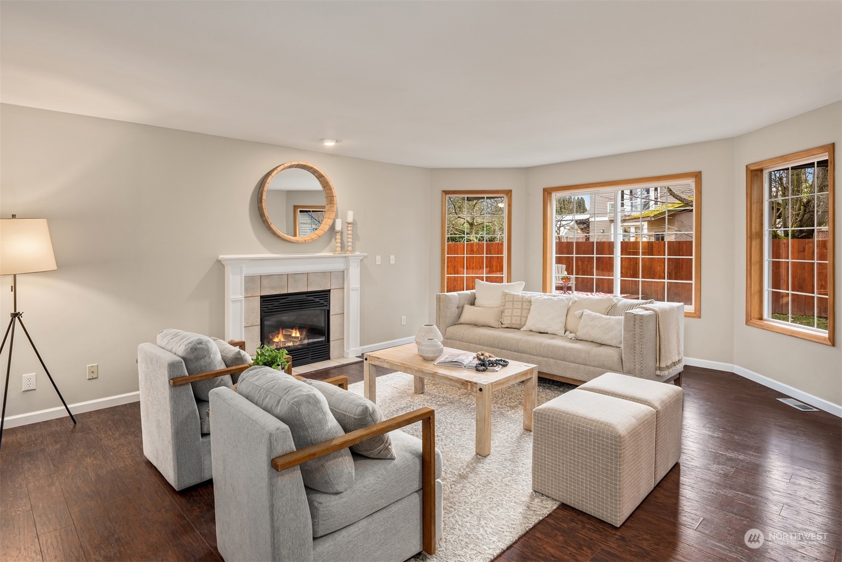 8722 Bowdoin Way Edmonds, WA 98026 - Photo 6 of 40 a living room with furniture a fireplace and a large window