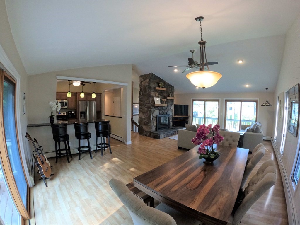 262 Flag Swamp Road Dartmouth, MA 02747 - Photo 11 of 23 a view of a dining room and a livingroom with furniture wooden floor a chandelier