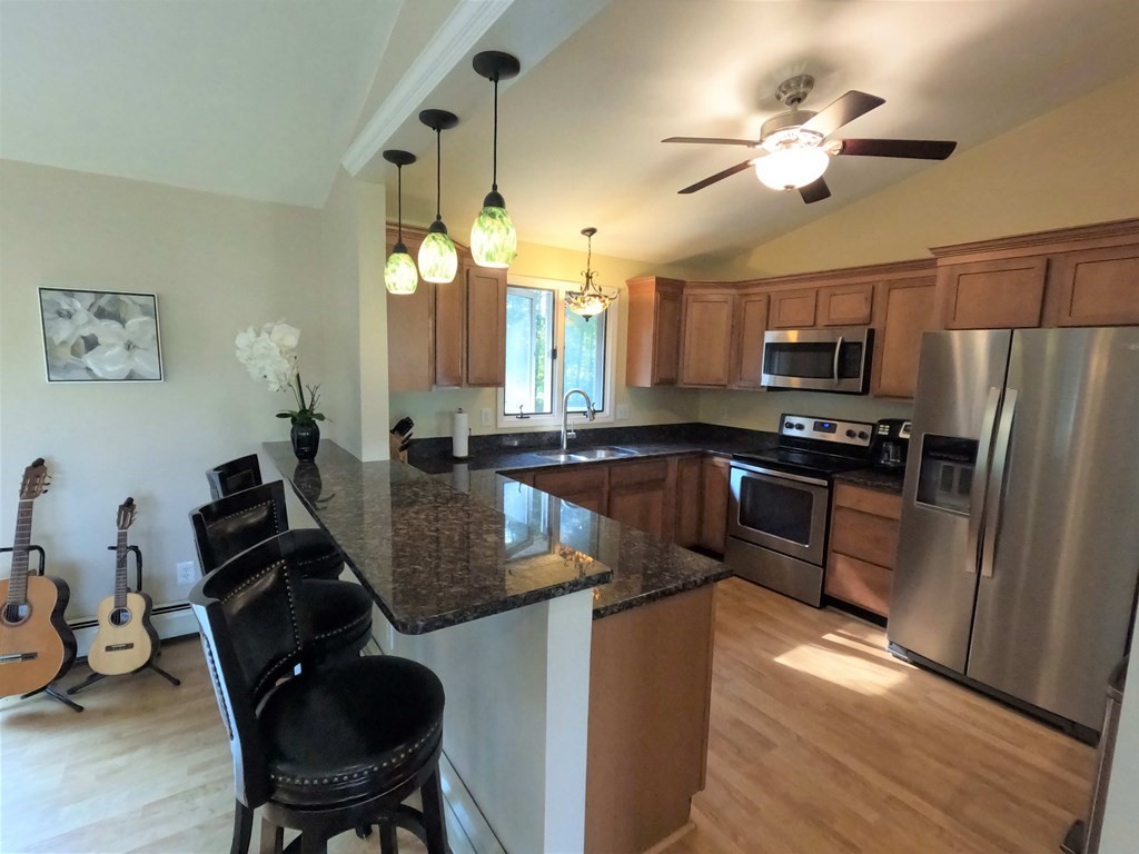 262 Flag Swamp Road Dartmouth, MA 02747 - Photo 13 of 23 a kitchen with a refrigerator cabinets and wooden floor