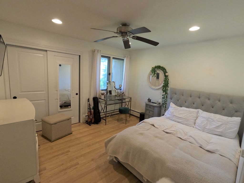 262 Flag Swamp Road Dartmouth, MA 02747 - Photo 19 of 23 a bedroom with a bed and a chandelier