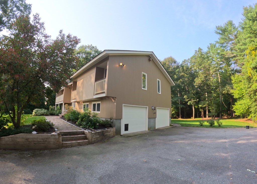 262 Flag Swamp Road Dartmouth, MA 02747 - Photo 3 of 23 a front view of a house with a yard and garage