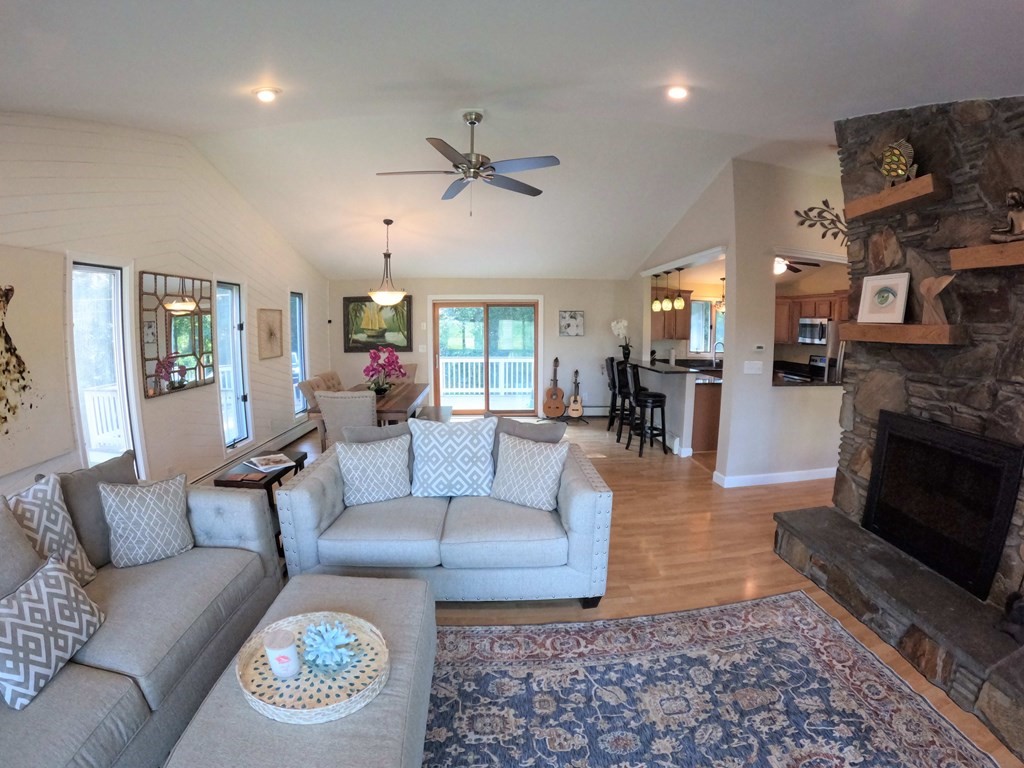 262 Flag Swamp Road Dartmouth, MA 02747 - Photo 10 of 23 a living room with furniture and a fireplace