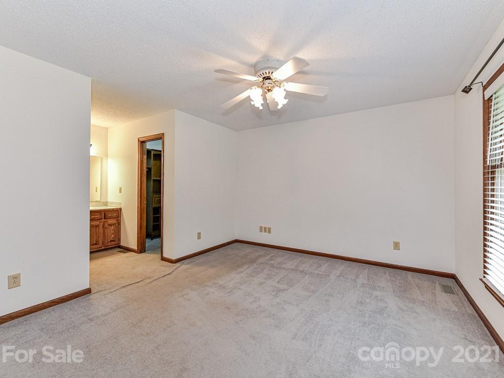 123 West Sandy Ridge Road Monroe, NC 28112 - Photo 14 of 32 an empty room with closet and a chandelier fan