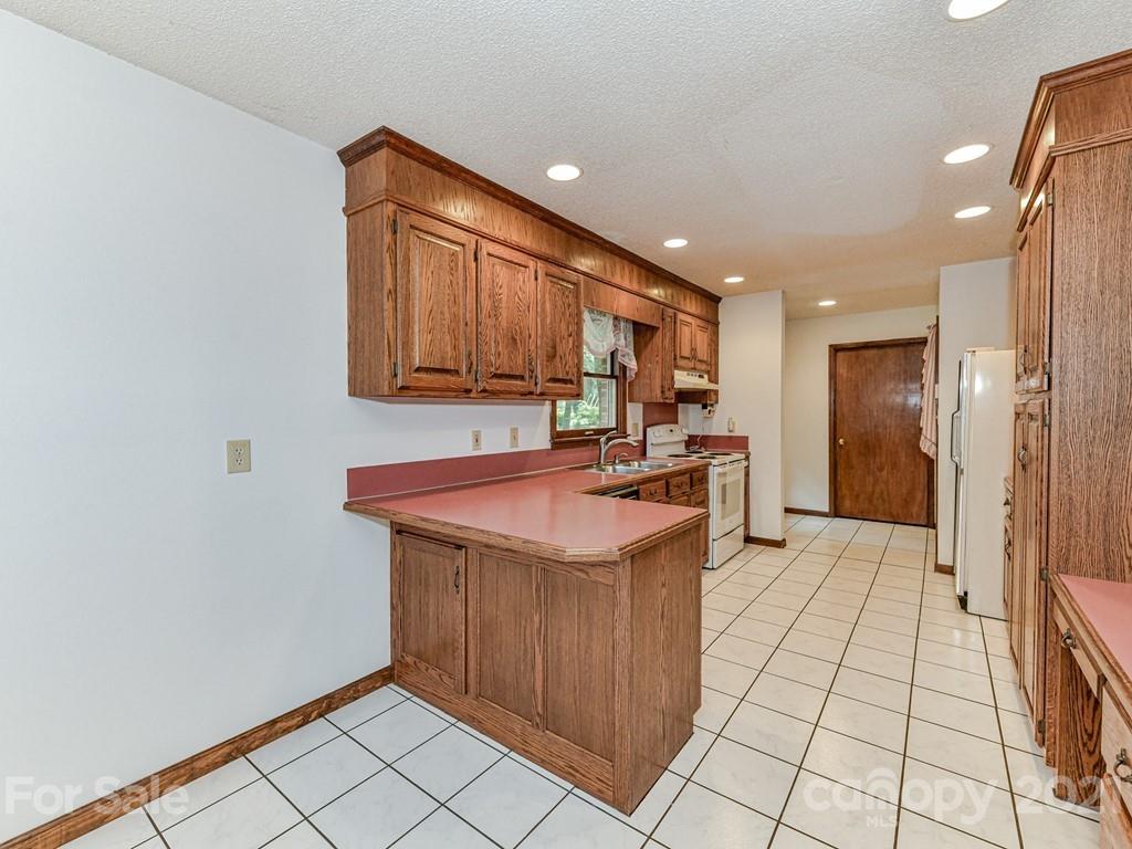 123 West Sandy Ridge Road Monroe, NC 28112 - Photo 8 of 32 a kitchen with stainless steel appliances granite countertop a sink a stove and a refrigerator