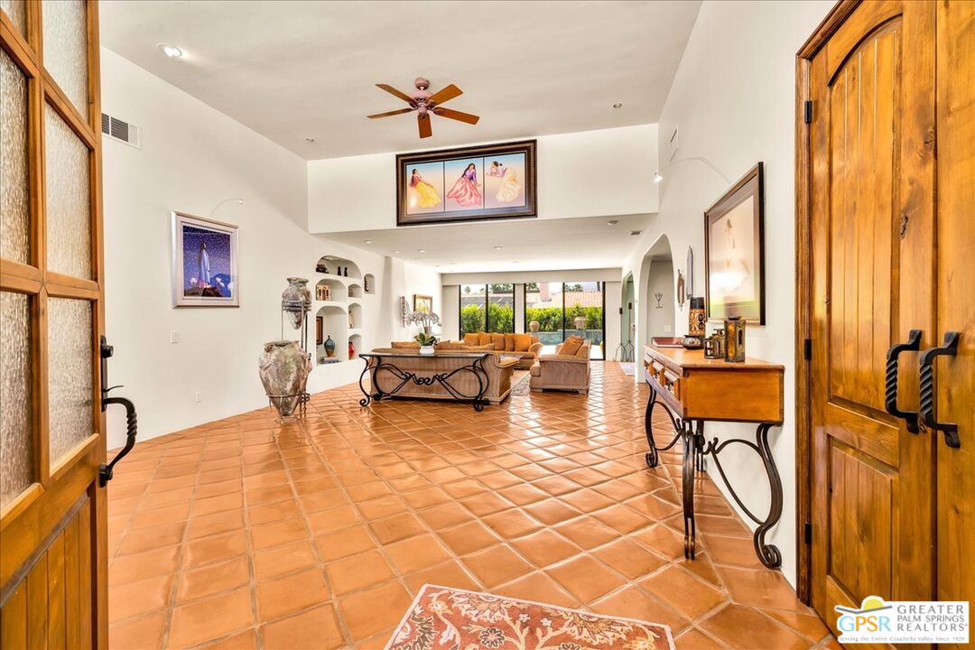 71121 Sunny Lane Rancho Mirage, CA 92270 - Photo 15 of 75 a living room with furniture a flat screen tv and a table