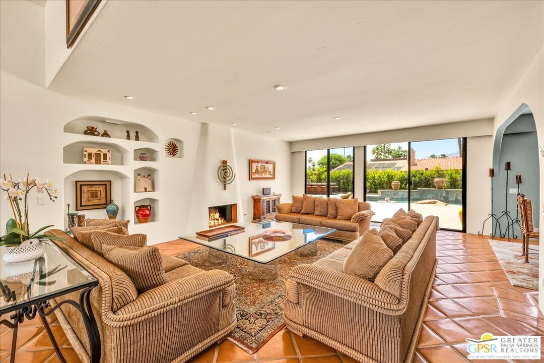 71121 Sunny Lane Rancho Mirage, CA 92270 - Photo 16 of 75 a living room with furniture and a floor to ceiling window