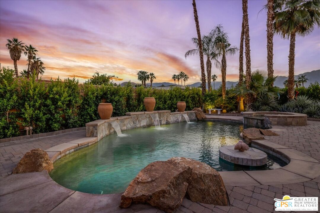 71121 Sunny Lane Rancho Mirage, CA 92270 - Photo 2 of 75 a view of a swimming pool with a table and chairs