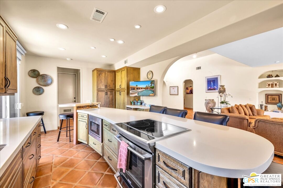 71121 Sunny Lane Rancho Mirage, CA 92270 - Photo 22 of 75 a large white kitchen with a large window